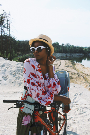 Woman Standing Beside Orange Mountain Bike Woman Standing Beside Orange Mountain Bike
