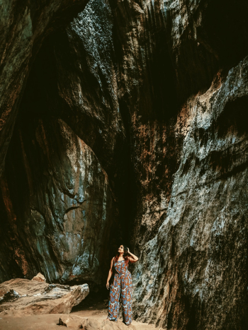 Woman Standing beside rocks Woman Standing beside rocks