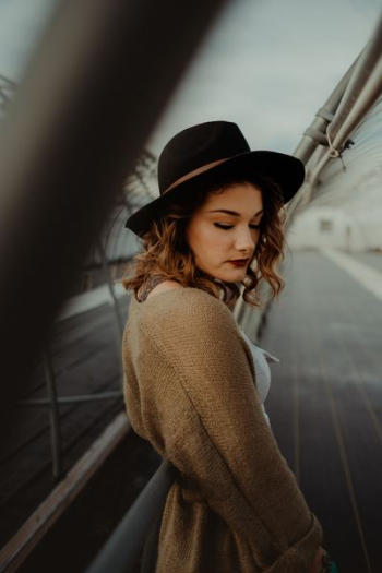 woman standing between white metal fences woman standing between white metal fences