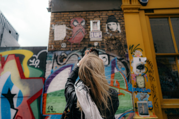 Woman Standing in Front of a Graffiti Wall Woman Standing in Front of a Graffiti Wall