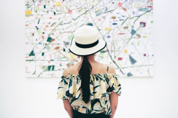 woman standing in front of abstract painting woman standing in front of abstract painting