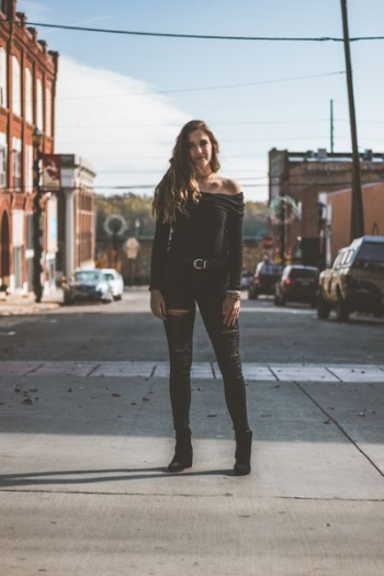 woman standing in the middle of street