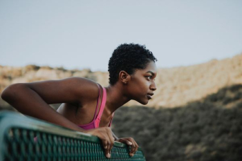 woman standing near metal fence during daytime