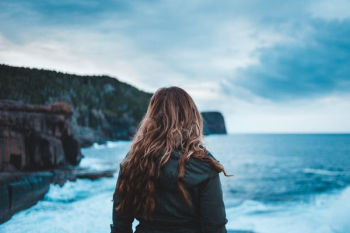 woman standing near sea woman standing near sea