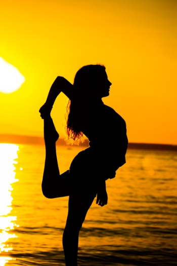 Woman Standing on Beach during Sunset Woman Standing on Beach during Sunset