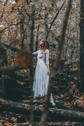 woman standing on forest trees