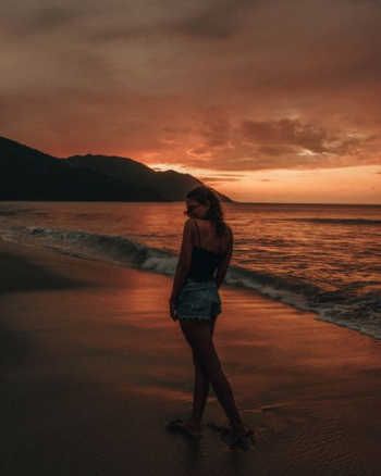 woman standing on sea shore woman standing on sea shore