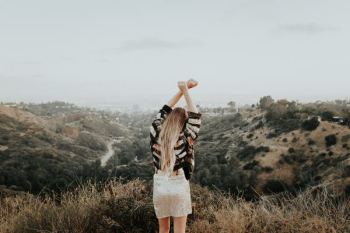 woman standing on top of mountain woman standing on top of mountain