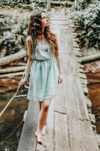 Woman Standing on Wooden Bridge Woman Standing on Wooden Bridge