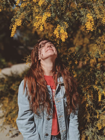 Woman Standing Under Yellow Leaf Tree