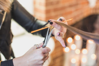 Woman Stylist Cuts Hair At Salon Woman Stylist Cuts Hair At Salon