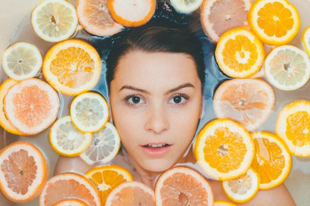 woman surrounded by sliced lemons woman surrounded by sliced lemons