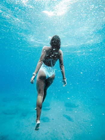 woman swimming under water