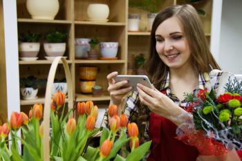Woman Taking a Photo of Orange Tulips Woman Taking a Photo of Orange Tulips