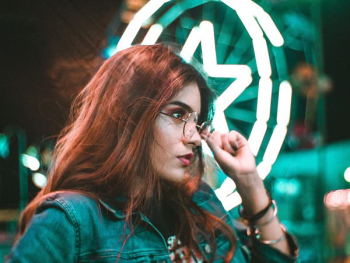 woman touching eyeglasses woman touching eyeglasses