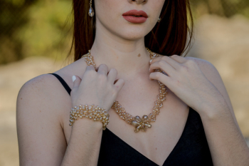 Woman Touching Gold Necklace Woman Touching Gold Necklace