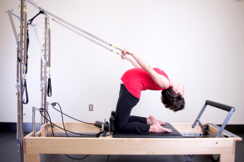Woman Using Exercise Equipment Woman Using Exercise Equipment