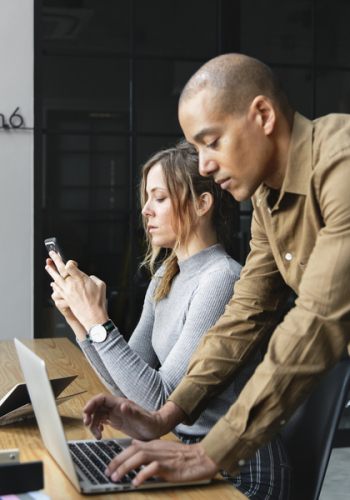 Woman Using Laptop Beside Woman Woman Using Laptop Beside Woman