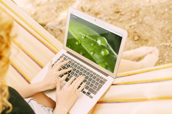 Woman using laptop mockup in nature Free Psd