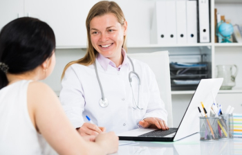 Woman visiting female doctor Woman visiting female doctor