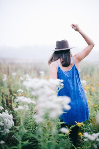 woman walking a flower field woman walking a flower field