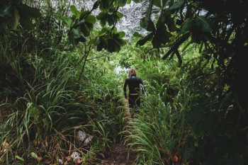 woman walking on animal trail during daytime woman walking on animal trail during daytime