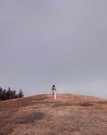 Woman Walking On Grass