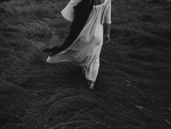 Woman Walking on Grass
