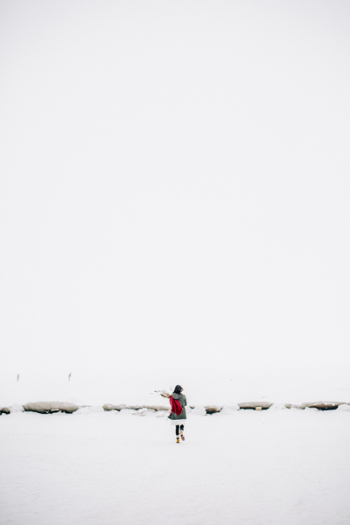 Woman Walking on Snow-covered Field Woman Walking on Snow-covered Field