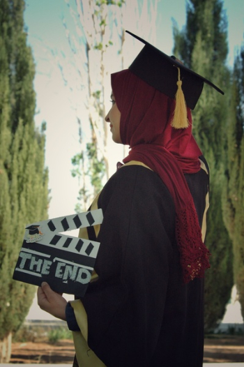 Woman Wearing Academic Dress While Holding Clipperboard Woman Wearing Academic Dress While Holding Clipperboard