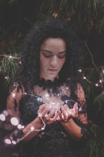 Woman Wearing Black Floral Dress Holding Fairy Light
