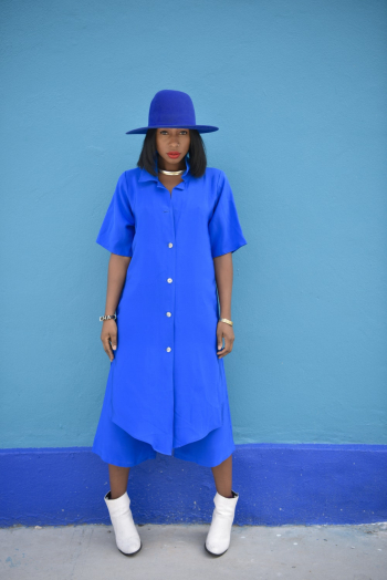 Woman Wearing Blue Dress Standing Beside Blue Painted Wall Woman Wearing Blue Dress Standing Beside Blue Painted Wall
