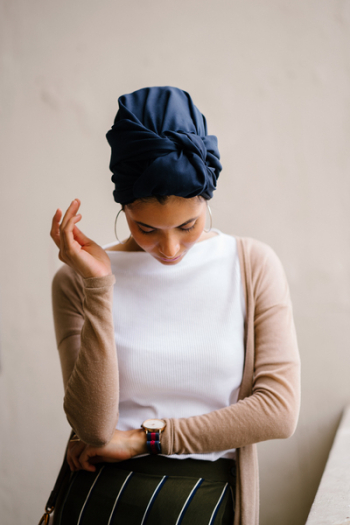 Woman Wearing Blue Turban, White Top and Brown Cardigan Woman Wearing Blue Turban, White Top and Brown Cardigan
