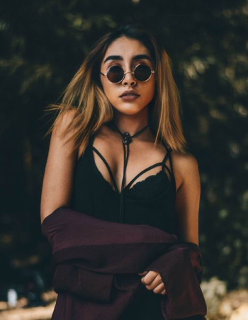 woman wearing cage neckline top and sunglasses woman wearing cage neckline top and sunglasses