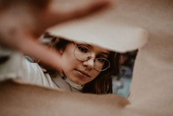 woman wearing gold framed eyeglasses woman wearing gold framed eyeglasses
