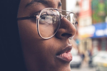 woman wearing gold framed eyeglasses during daytime