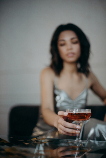 Woman Wearing Gray Dress Holding Wine Glass Woman Wearing Gray Dress Holding Wine Glass
