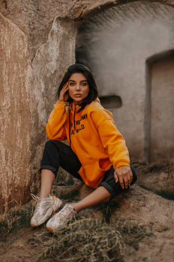 Woman Wearing Orange Pullover Hoodie and Black Capri Pants Woman Wearing Orange Pullover Hoodie and Black Capri Pants