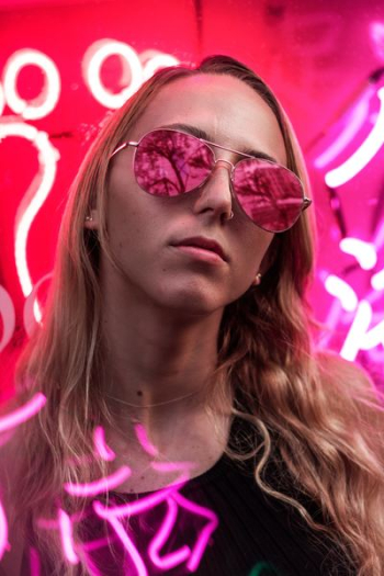 woman wearing pink sunglasses with silver frames woman wearing pink sunglasses with silver frames