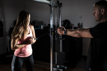 Woman Wearing Pink Tank Top and Black Leggings Working Out Woman Wearing Pink Tank Top and Black Leggings Working Out