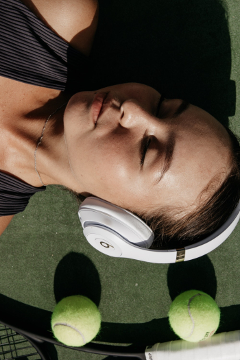Woman Wearing White Beats by Dr. Dre Wireless Headset Woman Wearing White Beats by Dr. Dre Wireless Headset