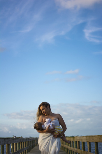 Woman Wearing White Dress Carrying Baby