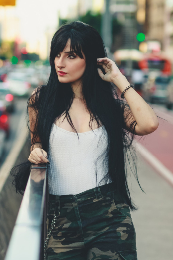 Woman Wearing White Shirt and Camouflage Bottoms Woman Wearing White Shirt and Camouflage Bottoms