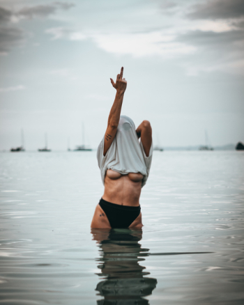 Woman Wearing White Shirt Raise His Middle Finger