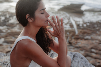 Woman Wearing White Tank Top Meditating Woman Wearing White Tank Top Meditating
