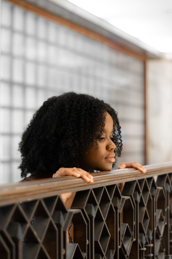 Woman with Curly Hair Leaning on Railings Woman with Curly Hair Leaning on Railings