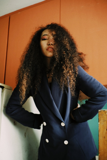 Woman With Curly Hair Wearing Blue Blazer Woman With Curly Hair Wearing Blue Blazer