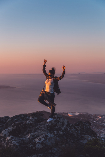 Woman With Hands Up Standing On Rock Woman With Hands Up Standing On Rock