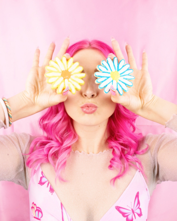 Woman with Pink Hair holding Flower Cookies Woman with Pink Hair holding Flower Cookies
