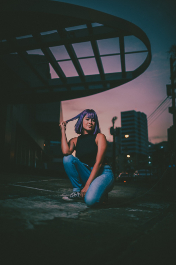 Woman With Purple Hair Color on Pavement Woman With Purple Hair Color on Pavement